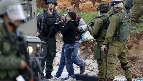 Israeli forces detain a Palestinian youth during clashes near Israel's Ofer prison. (AFP/File)