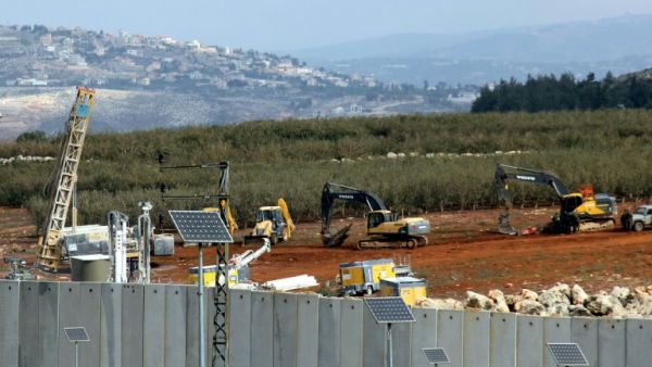 Israeli soldiers deploy excavators alongside the border wall with Lebanon on December 5, 2018. (AFP/File)