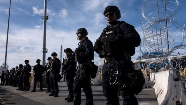 US border control agents stand in formation during a show of force as Central American migrants mass on the other side of the frontier (AFP Photo/Guillermo Arias)