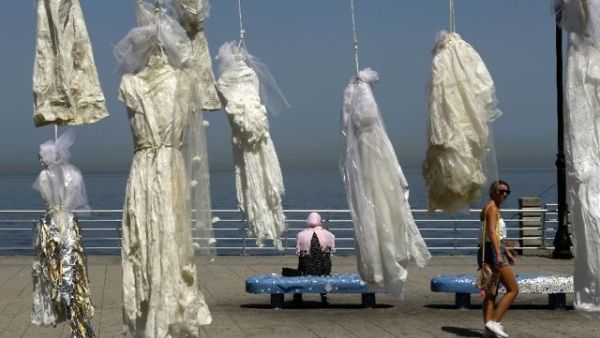 Lebanese activists use an installation of wedding dresses by Lebanese artist Mireille Honein at Beirut's Corniche to protest rape laws. (AFP)