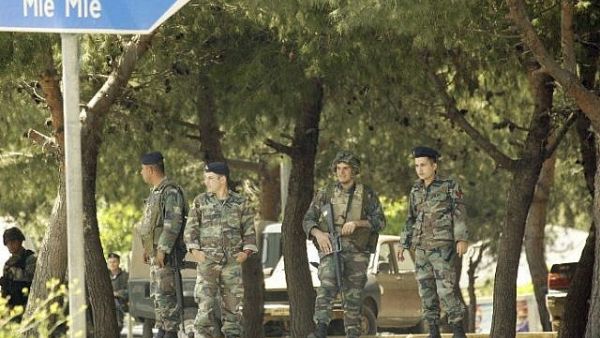 Soldiers stand guard on the road leading to Mieh Mieh Palestinian refugee camp on after clashes occurred between two different Palestinian factions. (AFP/File)