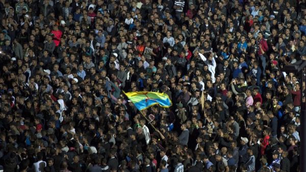 Protesters wave the Amazigh (Berber) flag as they shout slogans in the northern city of Al Hoceima on October 30, 2016, following the death of fishmonger Mouhcine Fikri, who was crushed to death on October 28 in a rubbish truck in Al Hoceima. (AFP/Fadel Senna)