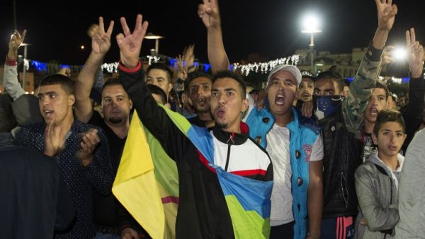 A protester carries the Amazigh (Berber) flag as protesters shout slogans in the northern city of Al Hoceima on October 30, 2016, following the death of fishmonger Mouhcine Fikri, who was crushed to death on October 28 in a rubbish truck. (AFP/Fadel Senna)