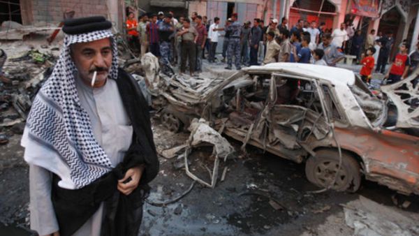 Residents gather at the site of a bomb attack in Basra. [AFP]