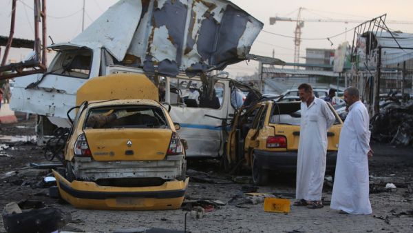 Two men inspect the aftermath of a Baghdad suicide bombing. (AFP/File)