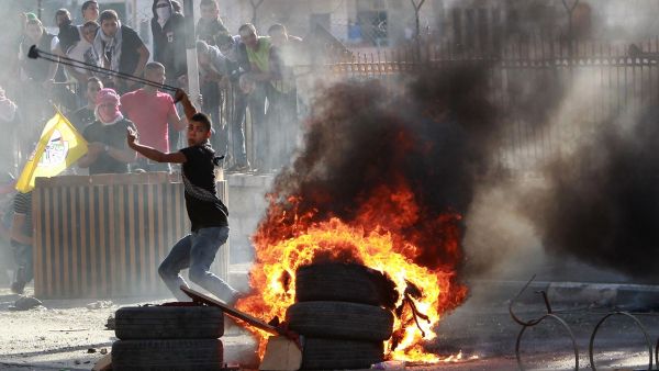 A file photo of a Palestinian youth throwing stones. (AFP/File)