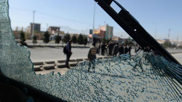 Afghan forces are seen through the shattered glass of a bus caught in a roadside bombing in Kabul. Improvised explosives are one of the main causes of civilian casualties. (AFP/File)