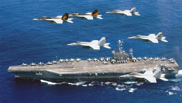This photo released on June 19, 2016 by the US Navy shows a flight formation of Boeing F/A-18E and F Super Hornets above the aircraft carrier USS John C. Stennis in the Philippine Sea. (AFP/File)