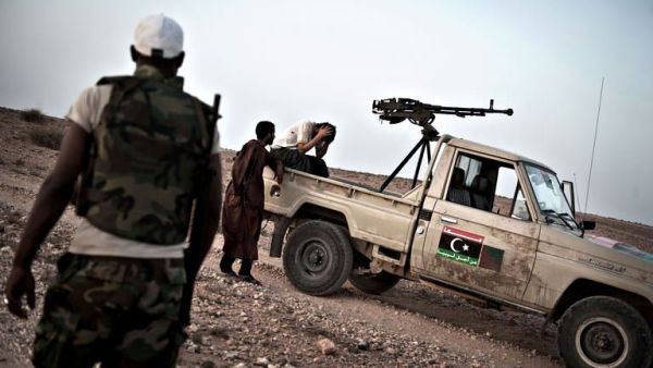A Libyan rebel fighter waits nervously for the road to be cleared of mines near the front line. (AFP/Colin Summers)