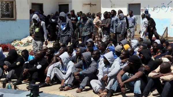 Refugees sit on the dock at the Tripoli port after being rescued by coast guard boats off the coast of Libya on June 7, 2016. (AFP/File)