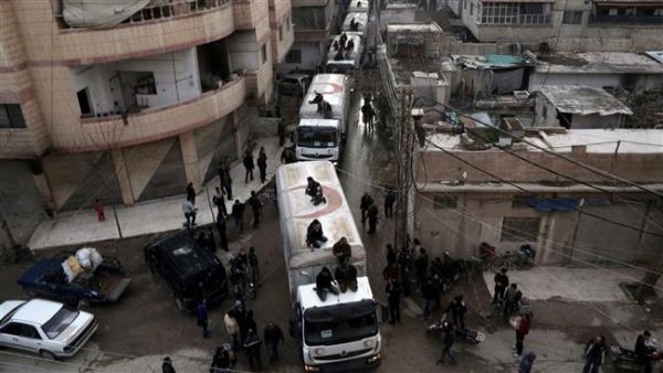 This photo taken on February 23, 2016 shows a Red Crescent convoy of humanitarian aid arriving in Kafr Batna, in the militants-held Eastern Ghouta area, on the outskirts of the capital, Damascus. (AFP/File)