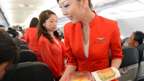 Up in the air: Air Asia Japan's cabin attendants provide the in-flight meal. (AFP/File)