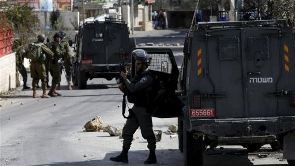 An Israeli trooper takes position during clashes with Palestinians in Arroub refugee camp, (AFP/File)