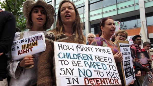 This image taken on February 4, 2016 shows human rights activists holding placards at a protest rally outside an immigration office in Sydney, Australia. (AFP/File)