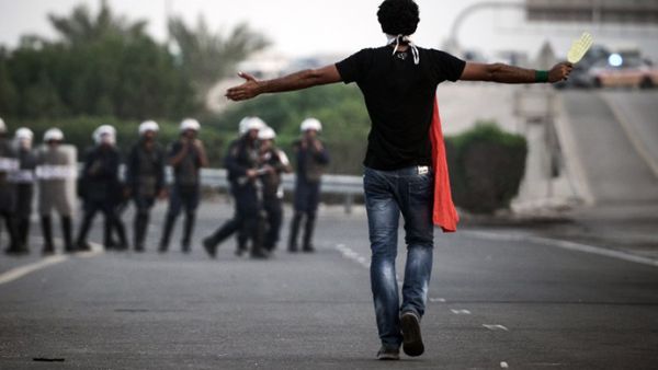 A Bahraini protester walks towards local riot police. (AFP/Mohammed Al Shaikh)