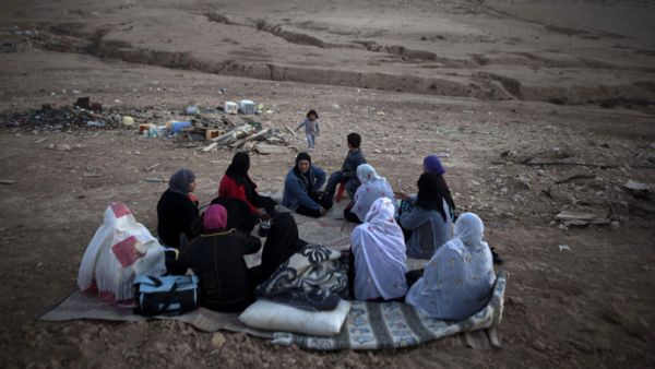 Bedouin women from al-Turi family sit next to their destroyed homes in their village. (AFP/File)