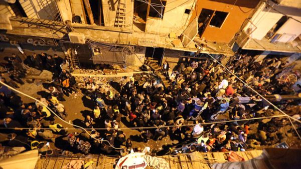 Civilians and army soldiers gather at the site of a twin suicide bombing in Burj al-Barajneh, in the southern suburbs of the capital Beirut. (AFP/File)