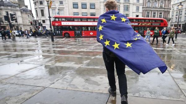 A demonstrator wrapped in a European flag leaves an anti-Brexit protest in Trafalgar Square, London. (AFP/File)