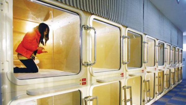 A woman trying out a cabinet-sized room at China's first capsule hotel in Shanghai. (AFP/File)