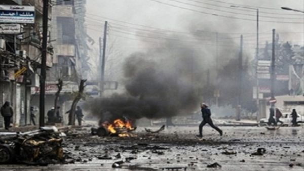 People use buckets to try and extinguish a fire that ignited at a local fuel station in the Bustan al-Qasr neighbourhood of Syria northern city of Aleppo on October 20, 2013. (AFP/File)