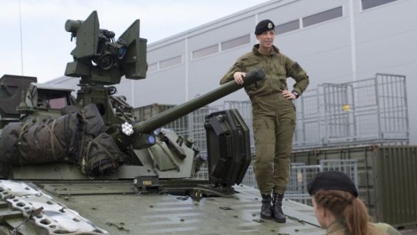 Female soldiers talk next to a CV90 combat vehicle. (AFP/File)