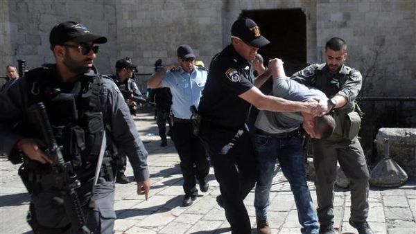 Israeli forces arrest a Palestinian man after Friday prayers at the entrance of Damascus Gate, Jerusalem. (AFP/File)