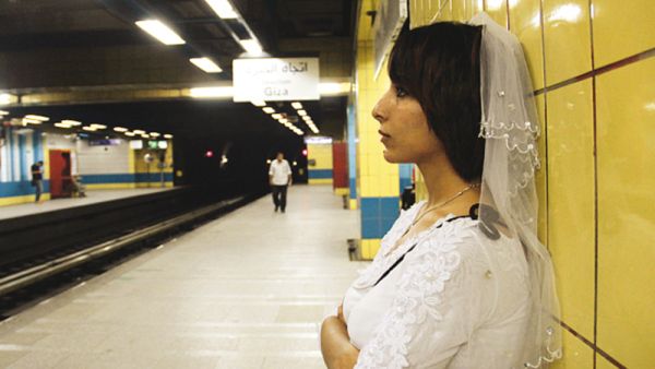 In early 2015, an unwed Egyptian woman named Samah Hamdi appeared in photos and video going through her daily routine donning a wedding gown and a veil in an attempt to ridicule communal pressure on Egyptian women to marry. (Courtesy photo)