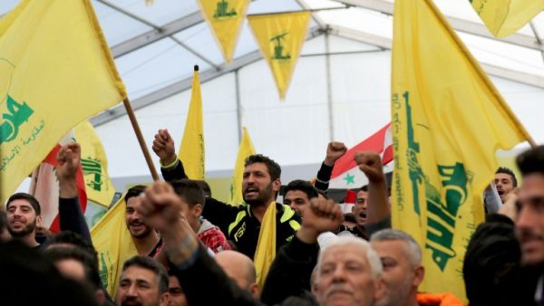 Supporters of Hezbollah chant slogans during a televised speech by leader Hassan Nasrallah. (AFP/File)