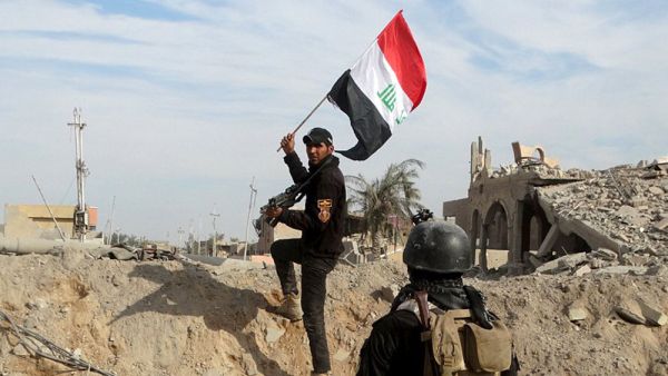 A soldier raises the Iraqi flag in Ramadi. (Twitter)
