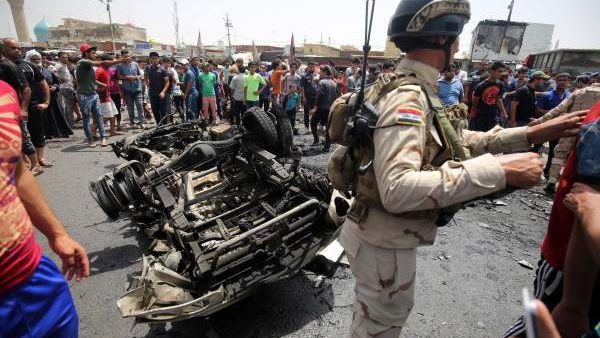 Iraqi army officials inspect the aftermath of Wednesday's car bomb attacks. (Twitter)