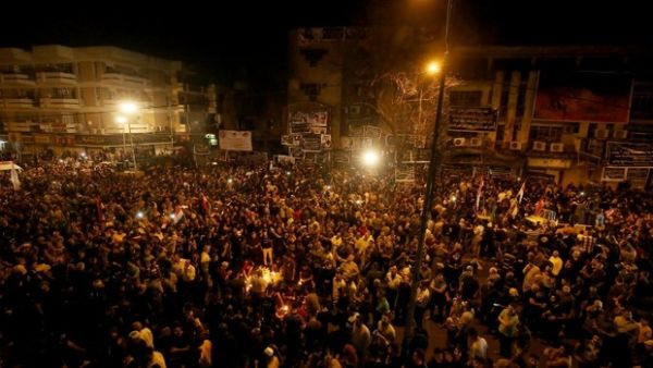 Iraqis gather at the site of the suicide car bomb which killed at least 250 people. (AFP/File)