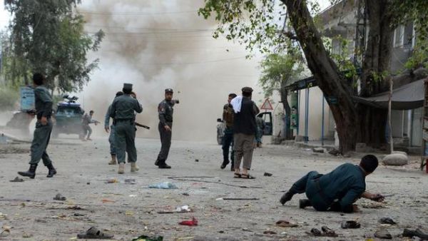 Security personnel look on after a second explosion following a suicide attack outside a bank in the eastern Afghan city of Jalalabad on April 18, 2015. (AFP/Noorullah Shirzada)