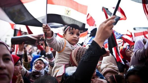 Egyptians wave the national flag in Cairo's Tahrir Square during a rally marking the anniversary of the 2011 Arab Spring uprising on January 25, 2014. (AFP/Virginie Nguyen Hoang) 