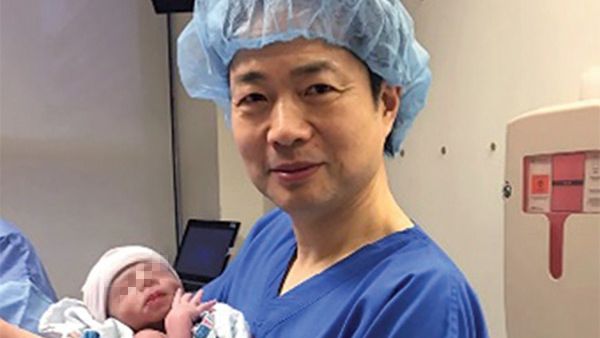 Doctor John Zhang holds the world's first baby with three genetic parents. (Courtesy photo)