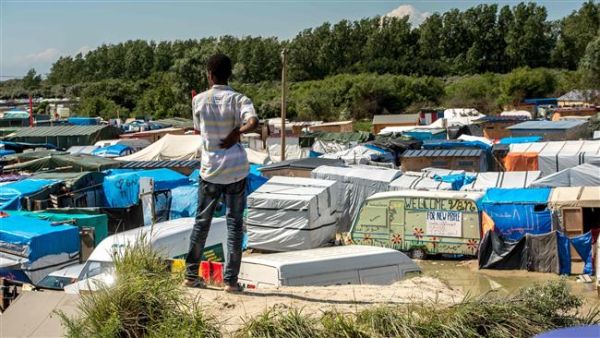 A refugee looks at the “Jungle” camp for in Calais on June 24, 2016. (AFP/File)