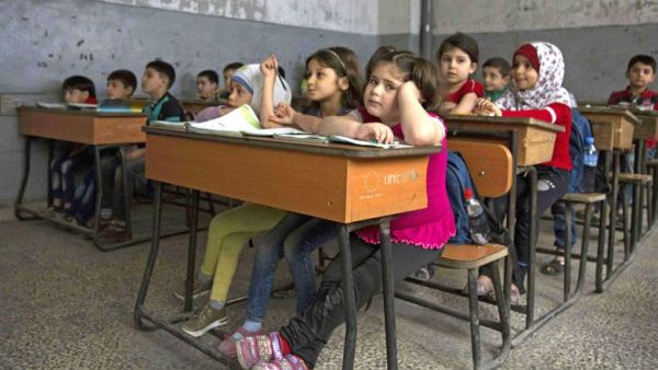 Syrian children attend a class at a primary school in Aleppo's rebel-held eastern district of Shaar on Saturday. (AFP/File)