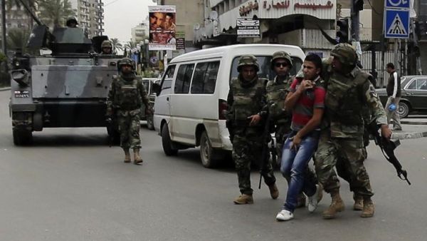 Lebanese army personal arrest a man in the northern Lebanese city of Tripoli. (AFP/File)