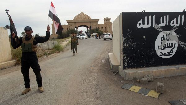 A Shia militia fighter celebrates the liberation of Tikrit. (AFP/Ahmed al-Rubaye)