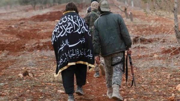 A member of al Qaeda's Nusra Front wears The Nusra flag as he walks with his fellow fighters near al-Zahra village, north of Aleppo city, November 25, 2014. (AFP/File)