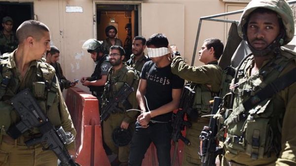 This file photo shows a Palestinian man arrested by Israeli soldiers in the occupied West Bank. (AFP/File)
