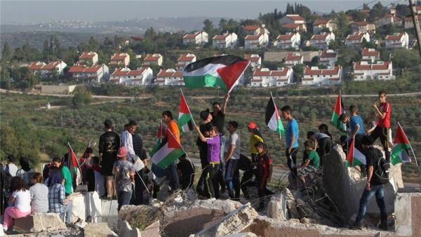 Palestinians from the West Bank protest near the Jewish Hallamish settlement. (AFP/File)