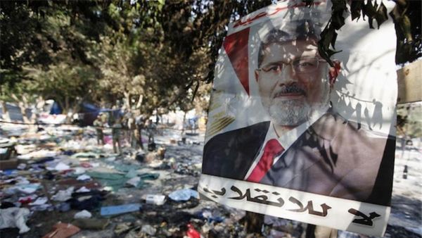 A picture of Egypt's ousted president Mohamed Morsi is seen hanging amidst debris at Rabaa al-Adawiya square in Cairo. (AFP/Mahmoud Khaled)