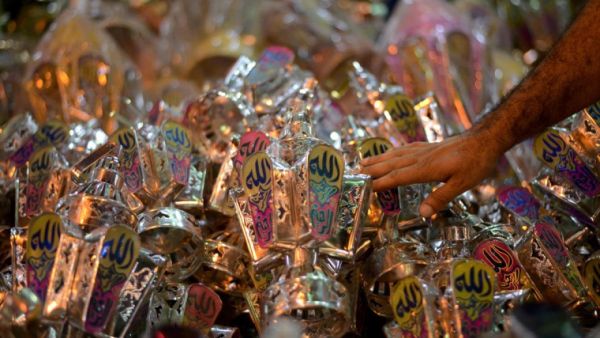 An Egyptian man selects a traditional lantern known in Arabic as "Fanous". (AFP/File)
