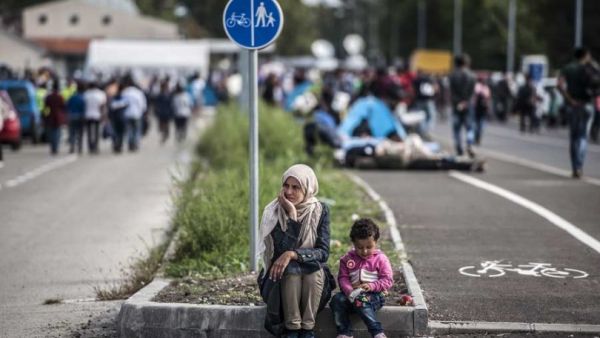 A mother and child sit on the street contemplatively. (AFP/Armend Nimani)