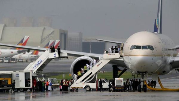 Television footage had shown the plane, reportedly carrying around 300 people, surrounded by dozens of security vehicles and officers armed with high-powered firearms at an isolated area of the runway at Manila's airport. (AFP/File)