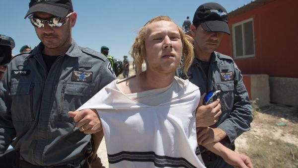 An Israeli settler being evacuated from an illegal settlement. (AFP/Menahem Kahana)