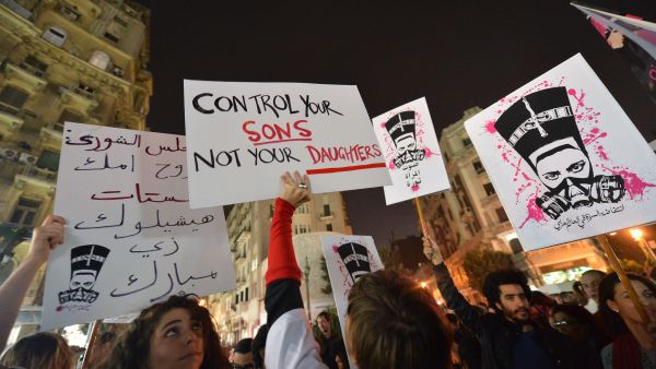 Egyptian protesters hold up placards and shout slogans during a demonstration in Cairo against sexual harassment on February 12, 2013. (AFP/File)