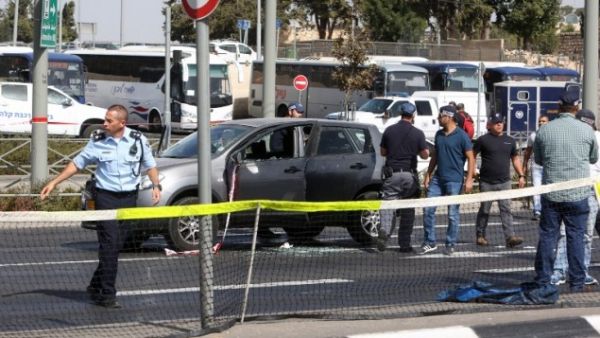 Israeli forensic policemen collect evidence from a car belonging to a victim following a shooting attack. (AFP/File)