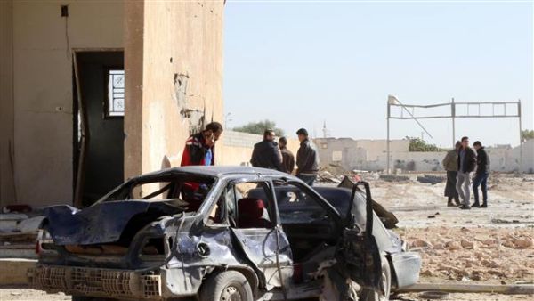 Libyans gather at the site of a deadly truck bombing on a police school in Libya's Sirte. (AFP/File)