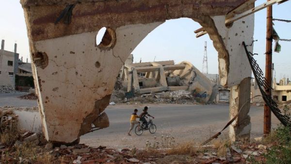 Syrian boys on a bicycle on May 14, 2016 in the southern city of Daraa. (AFP/File)